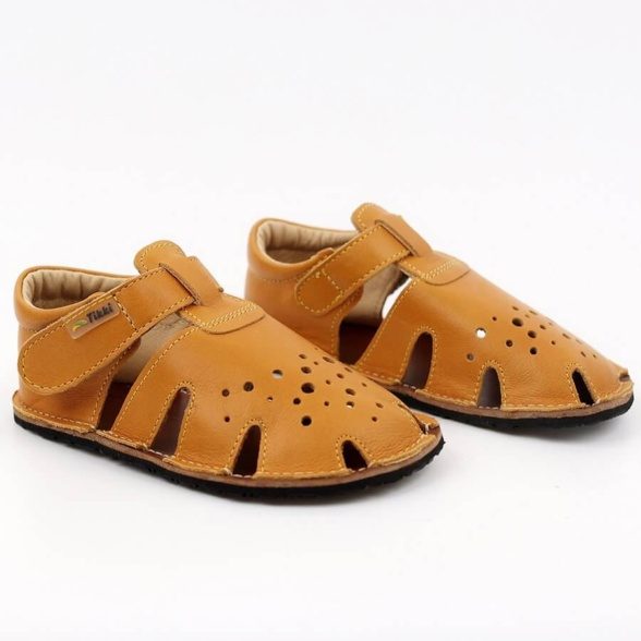 Tikki Aranya Mustard leather kids’ sandals. These barefoot sandals are breathable and feature velcro closures.