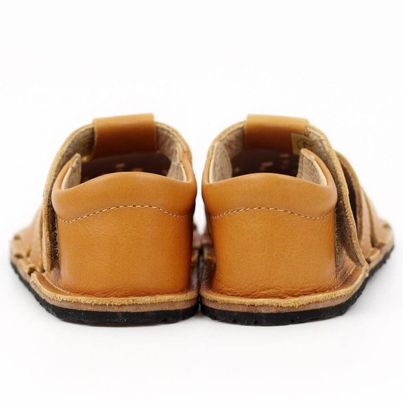 Tikki Aranya Mustard leather kids’ sandals. These barefoot sandals are breathable and feature velcro closures.